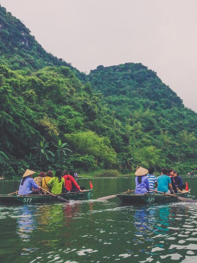 a group of people riding on top of a boat on a river