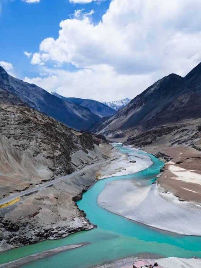 lake in the middle of mountains during daytime